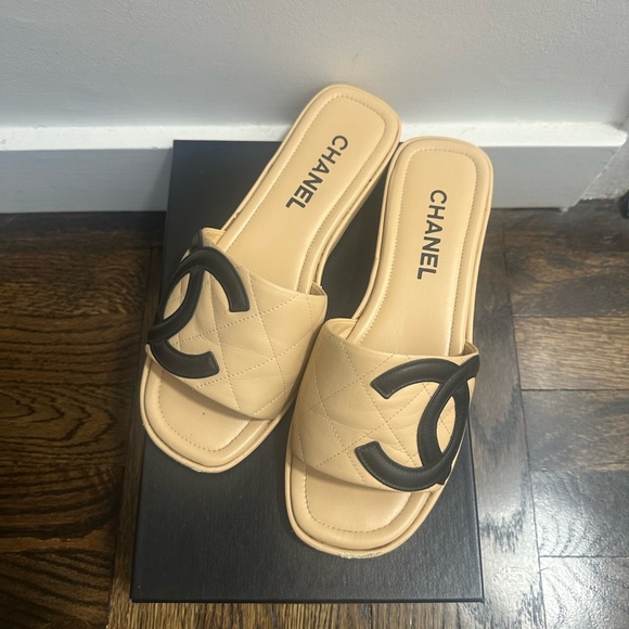 CHANEL Shoes - Chanel Cambon Beige Quilted Slides with Black Interlocking CC in Black